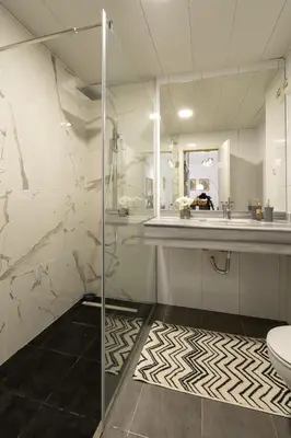 a bathroom with a shower and a sink and a toilet at City View Apartment by Homie in Funchal