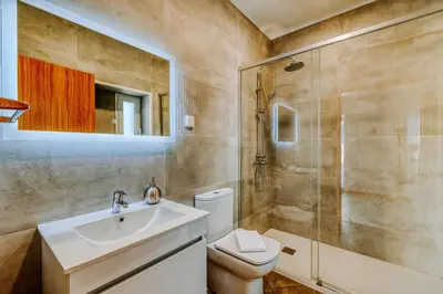 a bathroom with a toilet and a sink and a shower at Olinda's Place by Amazing Madeira in Boaventura