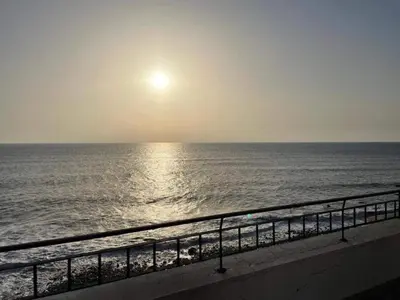 a view of the ocean at sunset from a balcony at Madalena Sunset by Homie in Madalena do Mar