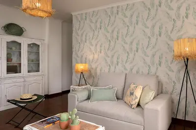 a living room with a couch and a wall at Madalena Sunset by Homie in Madalena do Mar