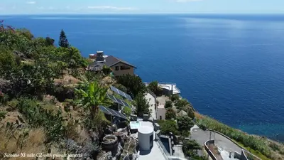 a house on a hill next to the ocean at Castelo do Mar, Madeira in Tábua