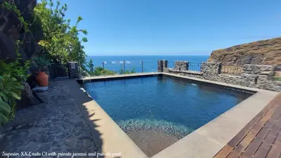 a swimming pool with the ocean in the background at Castelo do Mar, Madeira in Tábua