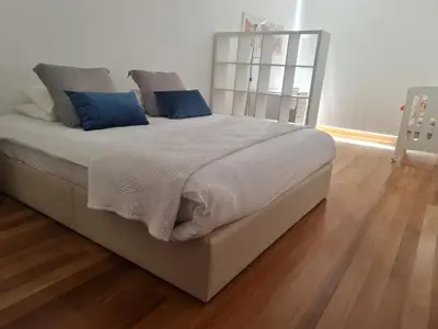 a bedroom with a large bed with blue pillows at Peaceful Apartment in Funchal