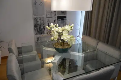 a living room with a glass table with a plant on it at Peaceful Apartment in Funchal