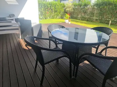 a patio with a table and chairs on a deck at Peaceful Apartment in Funchal