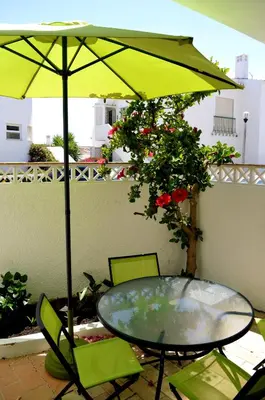 a table and chairs under an umbrella on a patio at Luz Studio in Luz