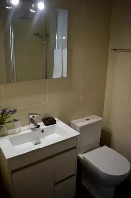 a bathroom with a toilet and a sink and a mirror at Luz Studio in Luz