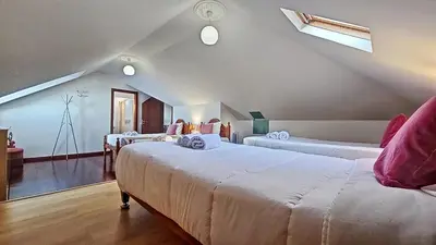 a bedroom with two beds in a attic at Casa do Seixal in Seixal