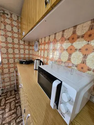 a kitchen with a sink and a microwave at CASA RIBEIRINHO No Coração da Natureza in Ponta do Pargo