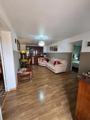 a living room with a couch and a table at CASA RIBEIRINHO No Coração da Natureza in Ponta do Pargo