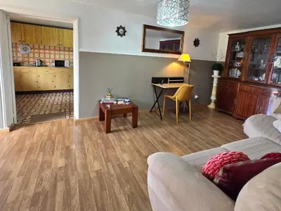 a living room with a couch and a table at CASA RIBEIRINHO No Coração da Natureza in Ponta do Pargo