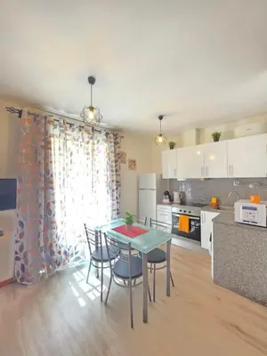 a bedroom with a bed and a table and a kitchen at Atlantic Studios #03 in Funchal