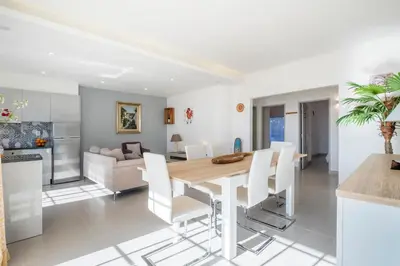 a dining room and living room with a table and chairs at Beautiful Seaview 2 Bedroom Apartment in Luz
