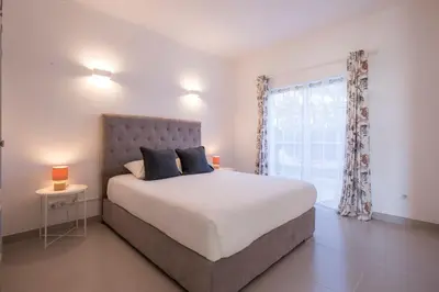 a bedroom with a large bed and a window at Beautiful Seaview 2 Bedroom Apartment in Luz