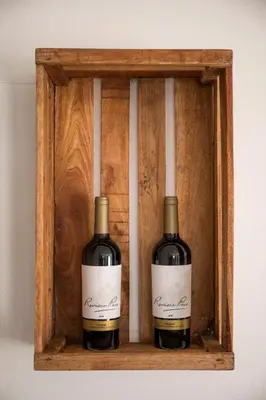 two bottles of wine sitting on a wooden shelf at Beautiful Seaview 2 Bedroom Apartment in Luz