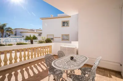 a patio with a table and chairs on a balcony at Beautiful Seaview 2 Bedroom Apartment in Luz