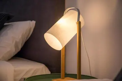 a lamp sitting on a table next to a bed at Beautiful Seaview 2 Bedroom Apartment in Luz