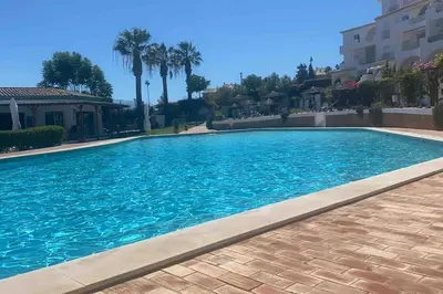 a large blue swimming pool in a house at Beautiful Seaview 2 Bedroom Apartment in Luz
