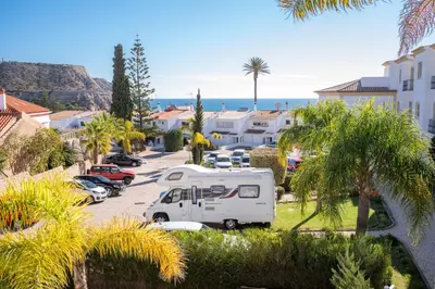 a white van parked in a parking lot near the ocean at Beautiful Seaview 2 Bedroom Apartment in Luz