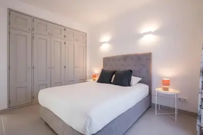 a bedroom with a large white bed with two lamps at Beautiful Seaview 2 Bedroom Apartment in Luz