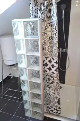 a glass shelf in a bathroom with a shower at Lazy Lizard Studio in Seixal