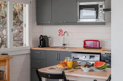 a kitchen with a table with food on it at Casa da Rocha de Baixo by An Island Apart in Santana