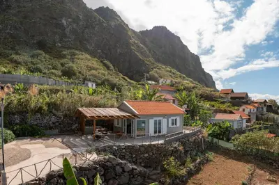 a small house on a hill with a mountain at Casa da Rocha de Baixo by An Island Apart in Santana