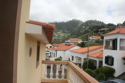 a bathroom with two sinks and a toilet in it at Charm Penthouse Ocean View in Calheta