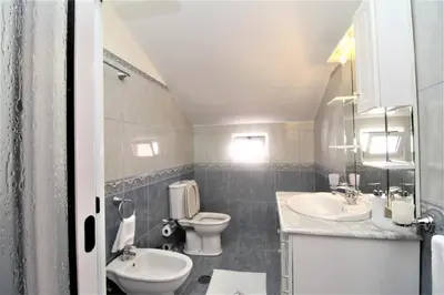 a bathroom with a toilet and a sink and a toilet istg at Charm Penthouse Ocean View in Calheta