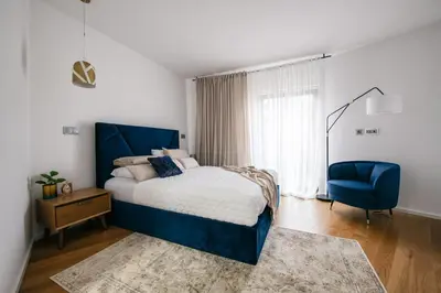 a bedroom with a blue bed and a blue chair at Funchal BEAUTIFUL vista mar in Funchal