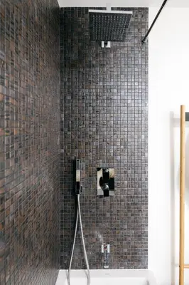 a bathroom with a shower with brown tiled walls at Funchal BEAUTIFUL vista mar in Funchal