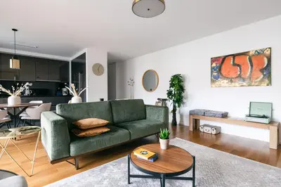 a living room with a green couch and a table at Funchal BEAUTIFUL vista mar in Funchal