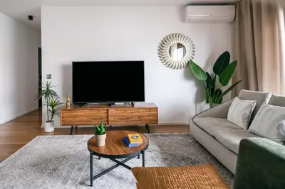 a living room with a couch and a tv at Funchal BEAUTIFUL vista mar in Funchal