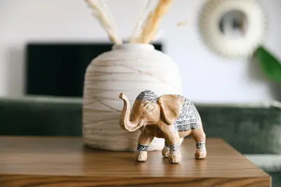 a small elephant figurine on a table next to a vase at Funchal BEAUTIFUL vista mar in Funchal