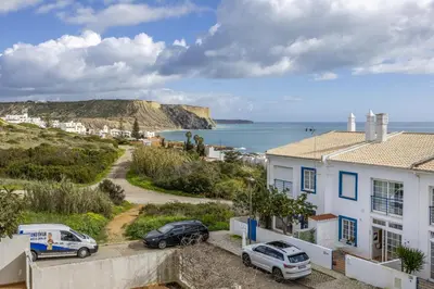a view of the ocean with a pink sky at CoolHouses Luz, Lovely 3 Bed Townhouse & sea views, Casa Baía da Vida in Luz