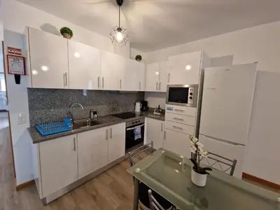 a kitchen with white cabinets and a sink at Atlantic Studios #01 in Funchal