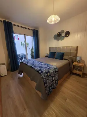 a bedroom with a bed and a large window at Atlantic Studios #01 in Funchal