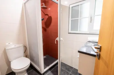a bathroom with a toilet and a shower at Madeira Bird House - House in the Mountains With Garden in São Vicente