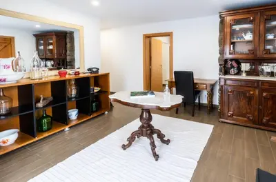 a room with a table in a room with cabinets at Madeira Bird House - House in the Mountains With Garden in São Vicente