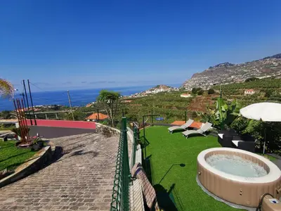 a garden with a hot tub in the grass at Villa Nova Madeira in Funchal Casa A and B in Funchal