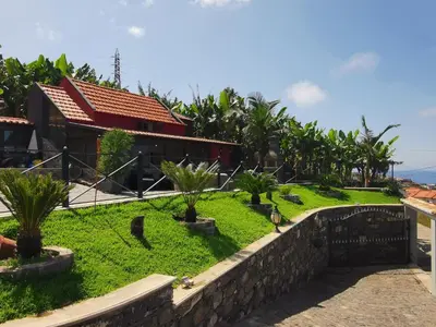 a house with a garden in front of it at Villa Nova Madeira in Funchal Casa A and B in Funchal
