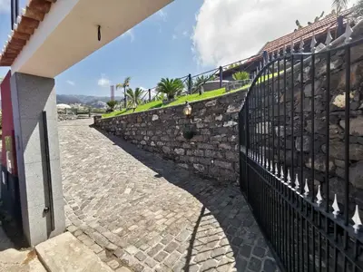 a stone fence next to a stone wall at Villa Nova Madeira in Funchal Casa A and B in Funchal