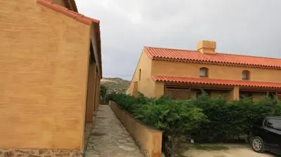 a house with a car parked in front of it at Casinha da Praia in Carrapateira