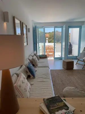 a living room with a couch and a table with a lamp at New! Casa do Mar - Pedralva - Sagres- Surf & Nature in Vila do Bispo