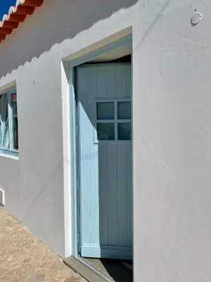 an open door in a white building with a window at New! Casa do Mar - Pedralva - Sagres- Surf & Nature in Vila do Bispo