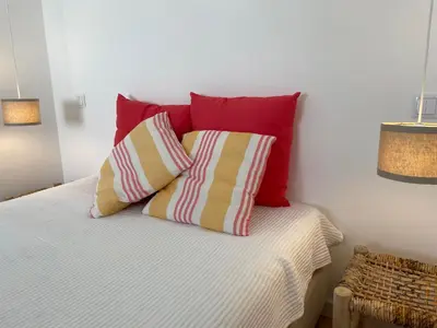 a bedroom with a bed with two pillows at New! Casa do Mar - Pedralva - Sagres- Surf & Nature in Vila do Bispo