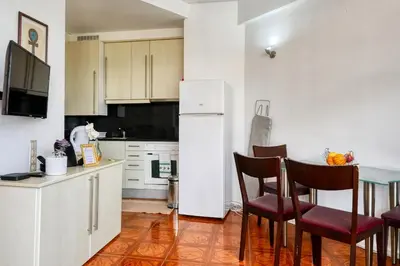 a kitchen with a white refrigerator and a table and chairs at Blue View, a Home in Madeira in Funchal