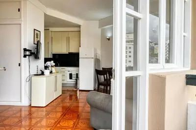 a kitchen with a white refrigerator and a table at Blue View, a Home in Madeira in Funchal