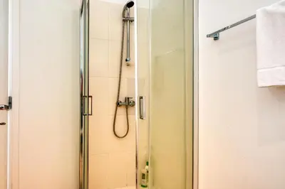 a shower with a glass door in a bathroom at Blue View, a Home in Madeira in Funchal