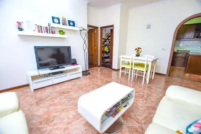 a living room with a television and a table at Authentic House in Funchal + City View in Funchal